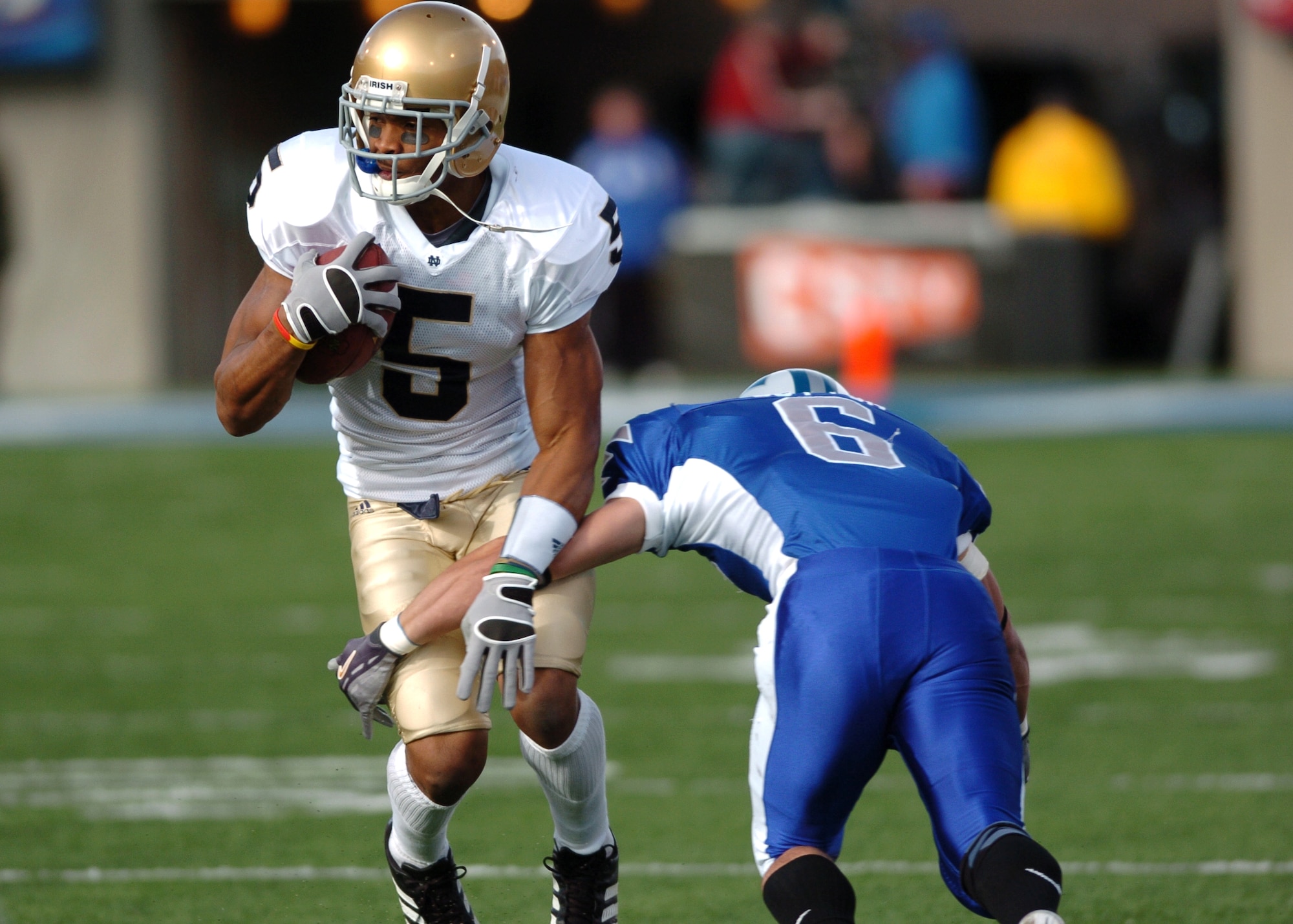 Notre Dame wide receiver Rhema McKnight side-steps Air Force cornerback Chris Sutton on a pass from quarterback Brady Quinn before picking up 20 yards and a first down.  Quinn threw for 207 yards and four touchdowns as the 8th-ranked Irish handily defeated the Falcons, 39-17.  (U.S. Air Force photo/1st Lt. John Ross)