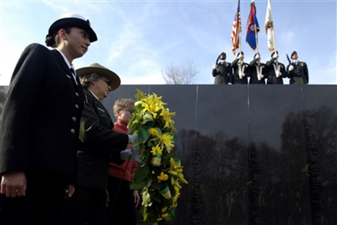 Petty Officer 2nd Class Elizabeth Lopez, left, an Iraq veteran, and representatives from the Vietnam Women's Memorial Foundation lay a wreath during the Veterans Day ceremony at the Vietnam War Memorial, Nov. 11, 2006. 