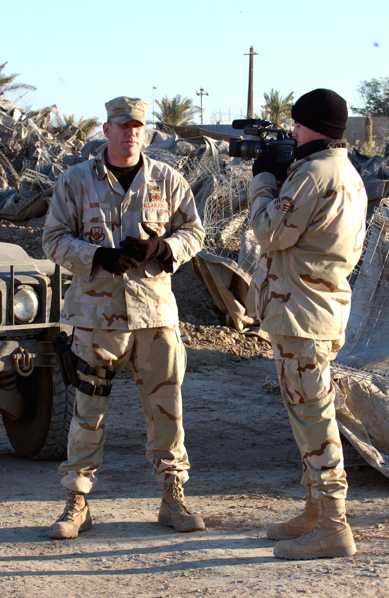 Staff Sgt. Justin Geers, left, Detachment 7, 732nd Expeditionary Security Forces Squadron briefs Senior Airman Blake Stilwell, a videographer from 1st Combat Camera Squadron, on Nov. 10.  The squadron's mission is to deploy into the city streets of Baghdad to assist Iraqi police in achieving self-sufficiency and enable orderly control of their battle space.  (U.S. Air Force photo/Master Sgt. Steve Cline)