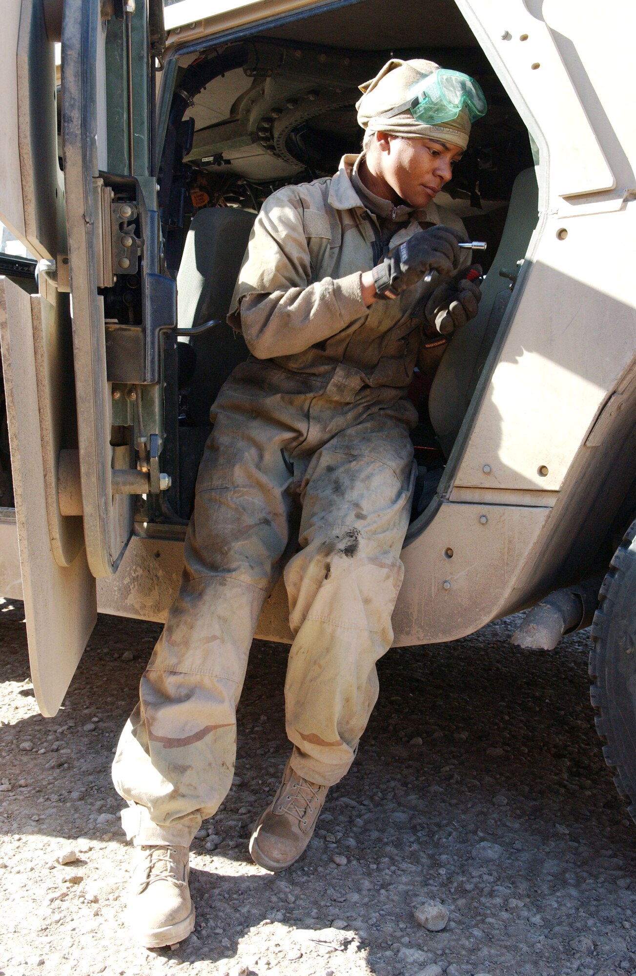 Staff Sgt. Charethea Payne repairs a high mobility, multi-wheeled vehicle, Nov. 10. Sergeant Payne is with Detachment 7, 732nd Expeditionary Security Forces Squadron. The mission is to deploy into Baghdad's streets and assist Iraqi police in achieving self-sufficiency and enable orderly control of their battle space. (U.S. Air Force photo/Master Sgt. Steve Cline)