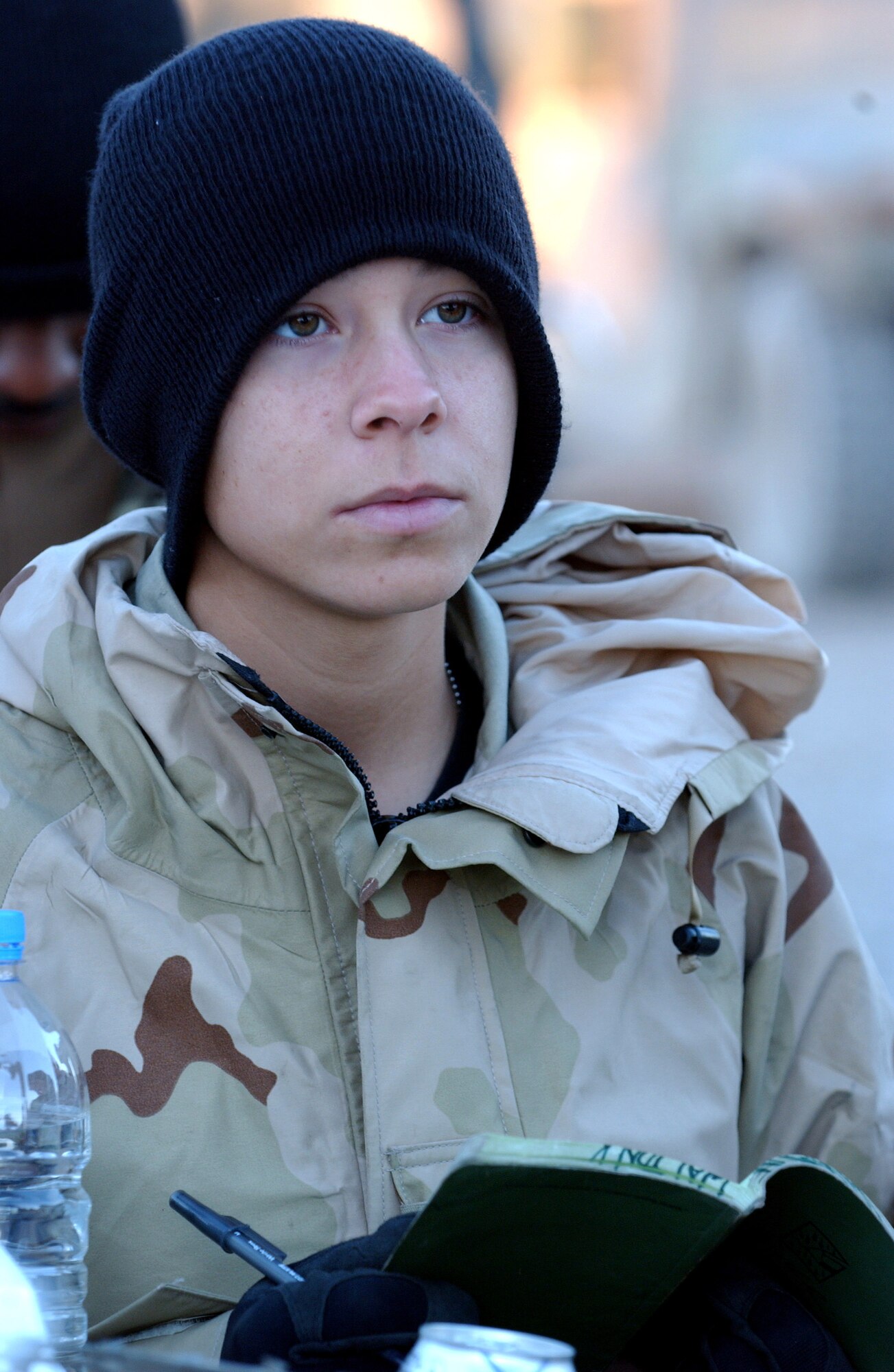 Airman 1st Class Kimberly Walton attends a mission brief prior to a patrol of Baghdad, Iraq, Nov. 10.  She is with Detachment 7, 732nd Expeditionary Security Forces Squadron whose mission is to deploy into the city streets to assist Iraqi police in achieving self-sufficiency and enable orderly control of their battle space. (U.S. Air Force photo/Master Sgt. Steve Cline)