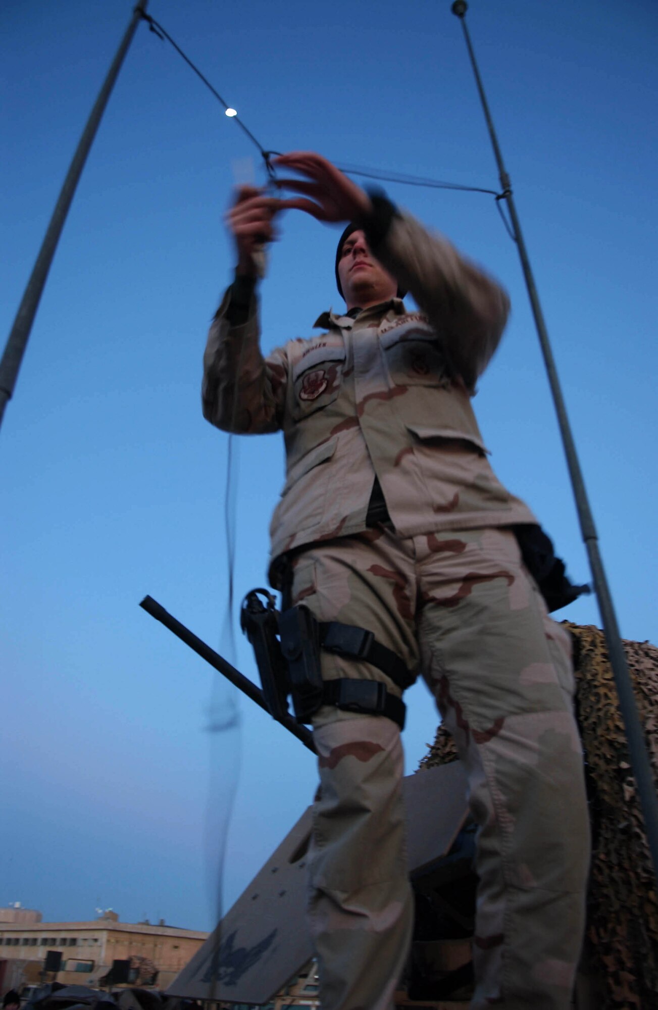 An Airman from Bravo Flight, Detachment 7, 732nd Expeditionary Security Forces Squadron adjusts the antenna of a high mobility, multi-wheeled vehicle prior to a mounted patrol in Baghdad, Iraq, Nov. 10, 2006. The security forces squadron's mission is to deploy into Baghdad's city streets to assist Iraqi police in achieving self-sufficiency and enabling orderly control of their battle space. (U.S. Air Force photo/Master Sgt. Steve Cline)