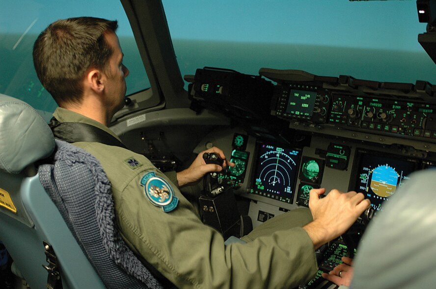 Lt. Col. Ed. Schloeman, a Reserve pilot with the 326th Airlift Squadron at Dover Air Force Base, Del., conducts training in a C-17 simulator at McGuire Air Force Base, N.J. Colonel Schloeman completed C-17 school this summer at Altus Air Force Base, Okla., and is required to log as much as 115 to 120 hours of simulator time as part of his training. The first of 13 C-17s is slated for arrival at Dover AFB late next year. The 512th Airlift Wing's 326th AS and the 436th AW's 3rd Airlift Squadron will take on the C-17 mission. (U.S. Air Force photo by 1st Lt. Marnee A.C. Losurdo)
