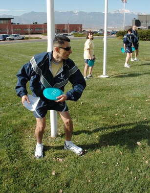 Staff Sgt. Alexander Cubas, 21st Logistics Readiness Squadron, takes aim in the Frisbee toss Nov. 9 during Wingman Day activities. (U.S. Air Force photo by Steve Brady)