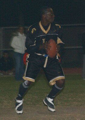 INCIRLIK AIR BASE, Turkey -- Bryan Shipman, 39th Logistics Readiness Squadron quarterback, looks for an open reciever to throw the ball to during intramural flag football playoff action against the 728th Air Mobitly Squadron on Nov. 9. LRS defeated AMS 31-21 to advance to the semi-final game aganst the SFS Nov. 13. (U.S. Air Force photo by Airman 1st Class Tiffany Colburn)                              
