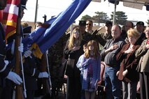 The family of Tech. Sgt. Jason Norton honors the American flag during the playing of the national anthem.  Sergeant Norton was a member of the 72nd Security Forces Squadron at Tinker Air Force Base, Okla., from 1994 to 1998 and was killed nine months ago while serving in Iraq. (Air Force photo by Margo Wright)