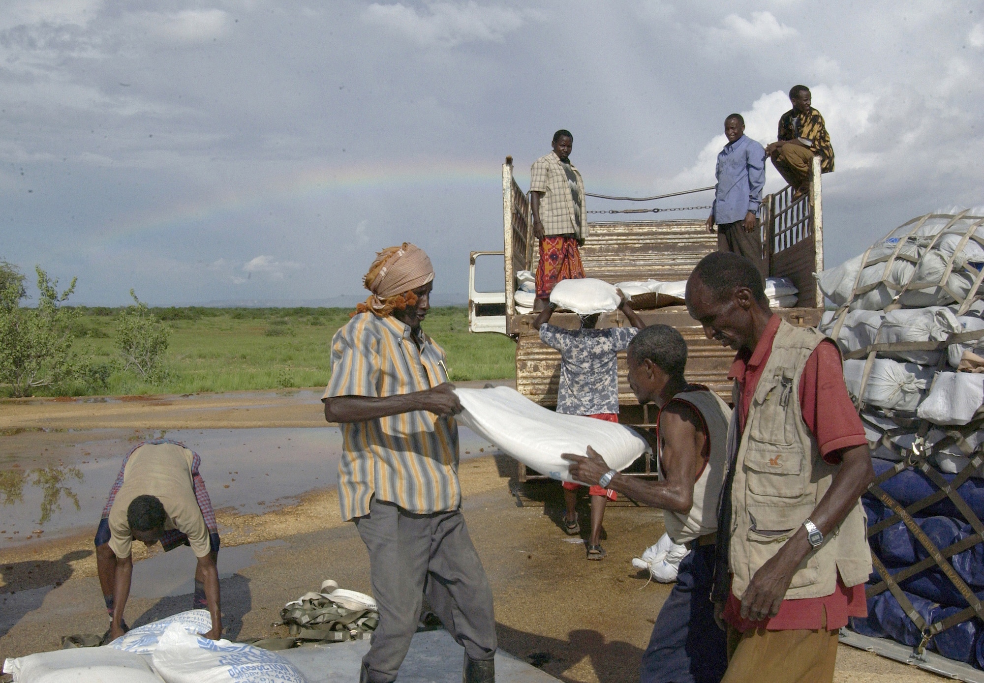 Local Ethiopians gather supplies on the taxiway in Gode, Ethiopia. C-130 Hercules aircraft assigned to Combined Joint Task Force - Horn of Africa delivered humanitarian aid to flood victims in the Ogaden region of Ethiopia Nov. 10. (U.S. Navy photo/Master Chief Petty Officer Philip A. Fortnam) 

 
