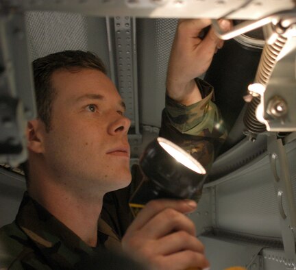 Air Force Reservist Staff Sgt. Michael Schuler inspects the left, main wheel well of A-10 number 201 Nov. 5, 2006, during the 442nd Fighter Wing's unit training assembly at Whiteman Air Force Base, Mo.  Sergeant Schuler is a phase inspection crew chief from the 442nd Maintenance Squadron whose job is to inspect A-10 Thunderbolt IIs for cracks, corrosion and wiring harness routes in need of repair during the phase inspection process.  Aircraft 201 recently returned from a four-month deployment to Afghanistan.  (U.S. Air Force photo/Maj. David Kurle)