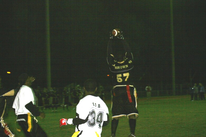 Sean Brown, 39th Logistics Readiness Squadron, catches a pass thrown by Brian Shipman 39th LRS. LRS beat SFS in overtime 14 to 7 on Nov. 13. LRS will play the 39th Contracting Squadron/Civil Engineer Squadron Nov. 14 at 6 p.m. for the championship. (U.S. Air Force photo by Senior Airman Patrice Clarke)