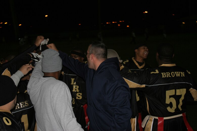 Members of the 39th Logistic Readiness Squadron's flag football team get pumped up before the semi-final game against the 39th Security Forces Squadron. LRS beat SFS in overtime 14 to 7 on Nov. 13. LRS will play the 39th Contracting Squadron/Civil Engineer Squadron Nov. 14 at 6 p.m. for the championship. (U.S. Air Force photo by Senior Airman Patrice Clarke)