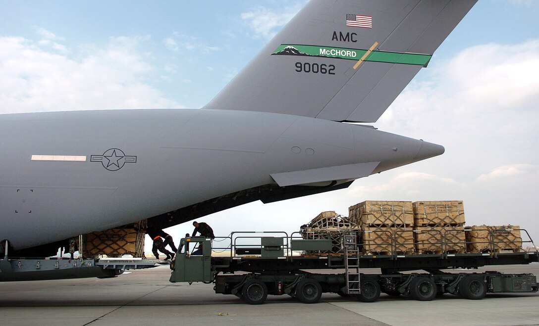 Airmen from the 728th Air Mobility Squadron load a C-17 Globemaster III at Incirlik Air Base, Turkey, Nov. 13. Over half of all air cargo delivered to support Operation Iraqi Freedom is processed through here. By flying critical supplies via Globemaster from this eastern Turkey air base directly to troops at remote locations in Iraq, more than 3,300 convoy truck missions and 9,000 servicemembers supporting the convoys are taken off Iraq roads each month. (U.S. Air Force photo/Tech. Sgt. Larry A. Simmons)