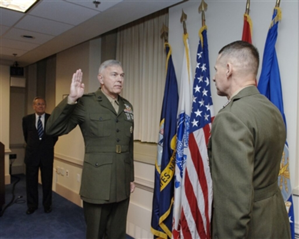 Secretary of Defense Donald H. Rumsfeld (left) looks on as Chairman of the Joint Chiefs of Staff Gen. Peter Pace (right), U.S. Marine Corps, administers the oath of office to Gen. James T. Conway (center), U.S. Marine Corps, during his promotion ceremony on Nov. 13, 2006.  Conway has been nominated to be the next Commandant of the Marine Corps.  
