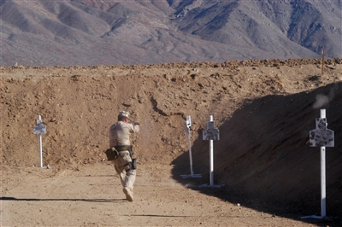 Senior Chief Petty Officer Michael G. Manning, an instructor at the new naval firing range attached to Explosive Ordnance Disposal Training and Evaluation Unit 1, simulates a firing course exercise at the China Lake, Calif., facility, Nov. 8, 2006.