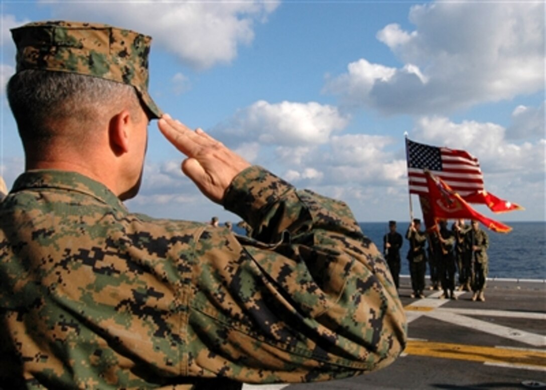 U.S. Marine Corps Col. Ronald J. Johnson salutes during the celebration of the 231st birthday of the U.S. Marine Corps on the flight deck of the USS Iwo Jima, Nov. 10, 2006.