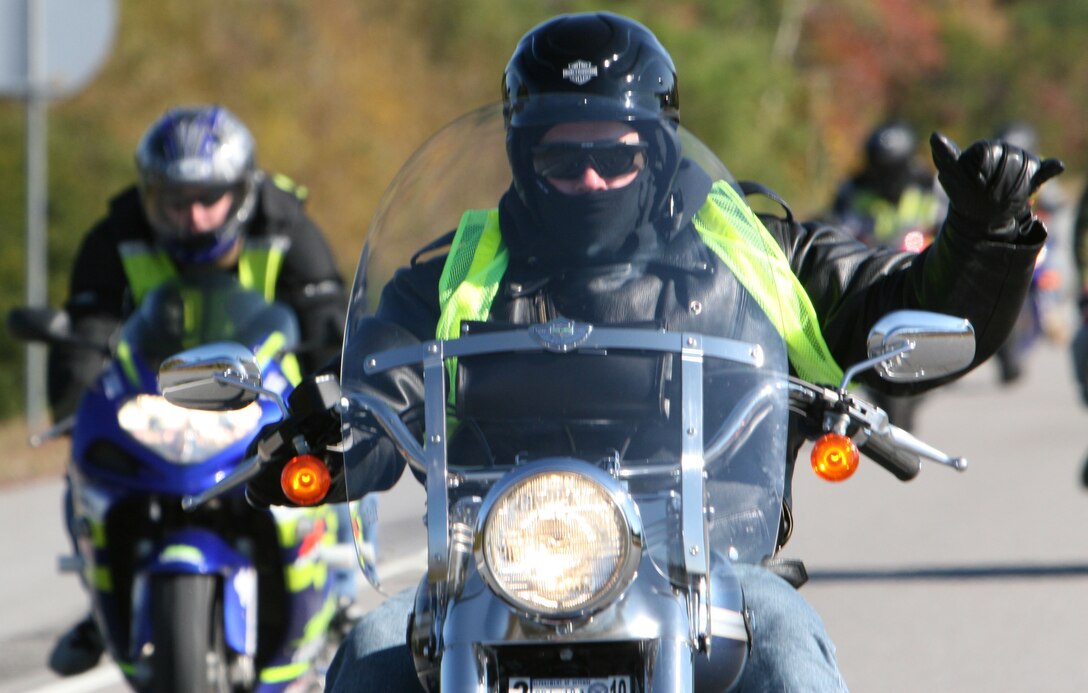 A rider from Combat Logistics Regiment 2 and Combat Logistics Regiment 27, 2nd Marine Logistics Group, poses for the camera while participating in a motorcycle ride to the Battleship North Carolina in Wilmington, N.C., Nov. 16.  The motorcycle ride was a day for the Marines of 2nd MLG to promote motorcycle safety and allowed less experienced riders to practice proper safety procedures.
