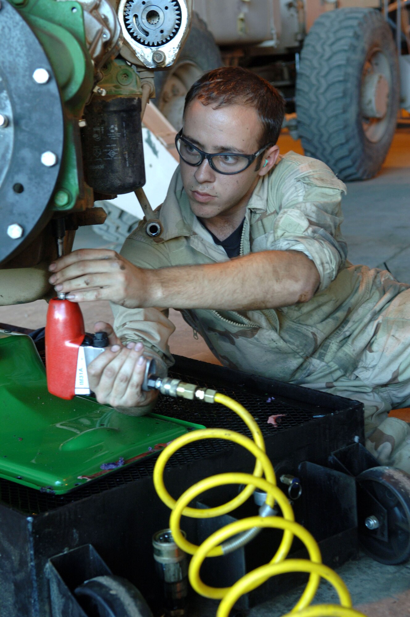 Staff Sgt. Matthew Muir, 332nd Expeditionary Logistics Readiness Sqadron, swaps out an oil pan in the maintenance shop at Balad Air Base, Iraq. Sergeant Muir is a vehicle maintenance journeyman deployed from Royal Air Force Lakenheath, England. (U.S. Air Force photo/Airman 1st Class Chad Kellum) 
