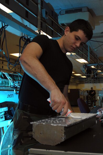 EIELSON AIR FORCE BASE, Alaska -- Airman First Class Robert Wulff, Electronic Warfare Systems Apprentice, 354th Maintenance Squadron, 354th Fighter Wing, Eielson Air Force Base, Alaska, applies heat sync troubleshooting a high voltage power supply on an ANALQ1 84 ECM (Electronic Counter Measures) Pod here on 15 November.
(U.S. Air Force Photo by Staff Sgt Joshua Strang)