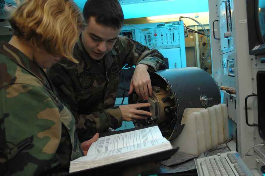 EIELSON AIR FORCE BASE, Alaska -- Airman First Class Matthew Orr and Airman Heather Mangerson, 354th Maintenance Squadron, 354th Fighter Wing, Eielson Air Force Base, Alaska, install a slip ring onto an F-16 targeting pod here on 15 November.
(U.S. Air Force Photo by Staff Sgt Joshua Strang)