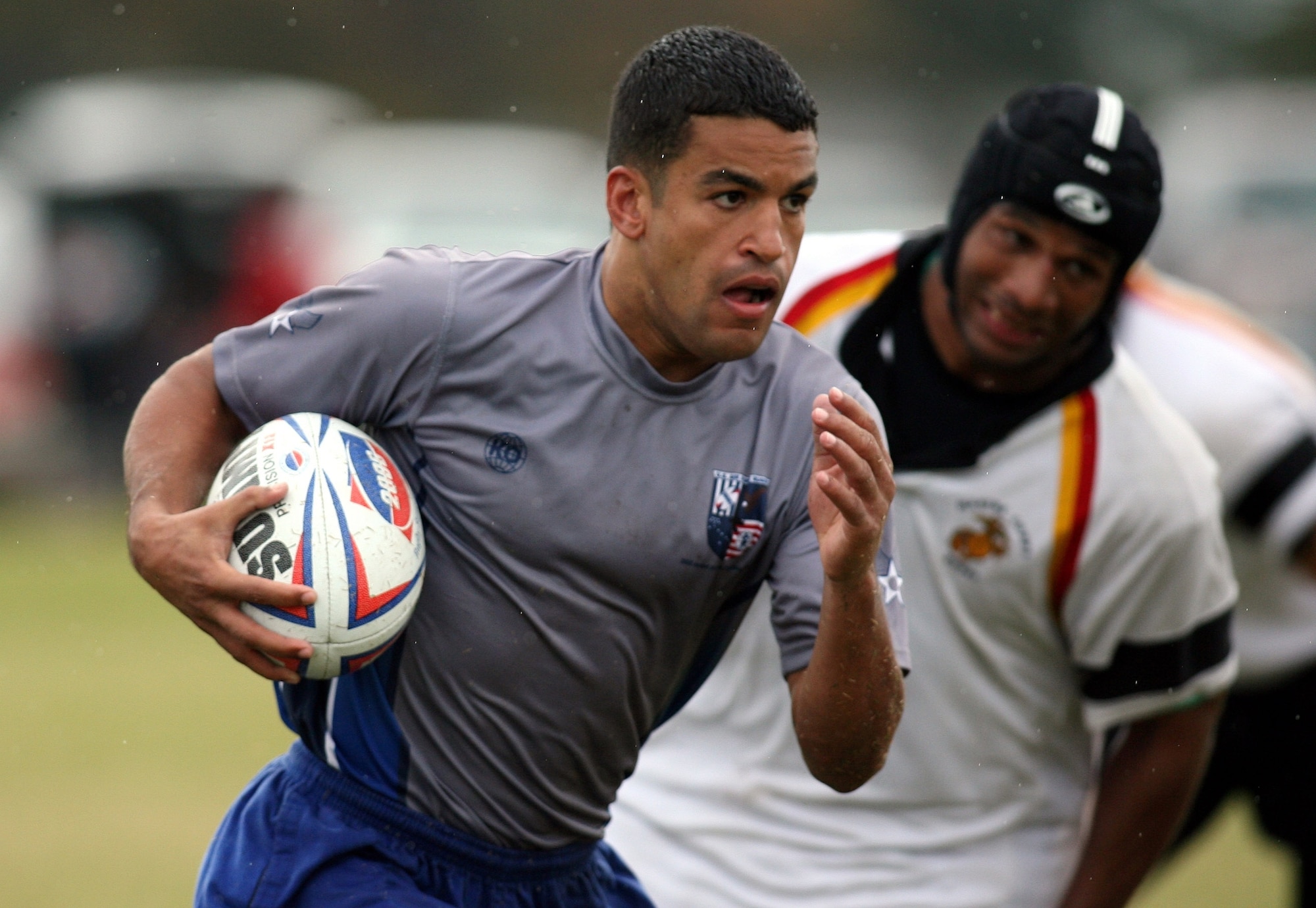 Air Force 1st Lt. David Pina runs past Army defenders during their match Oct. 23 at the Armed Forces Rugby Championship at Camp Lejeune, N.C.  The Air Force team, which went on to win its third consecutive tournament title, edged the Army team 5-3.  (U.S. Air Force photo/Major Scott Foley)