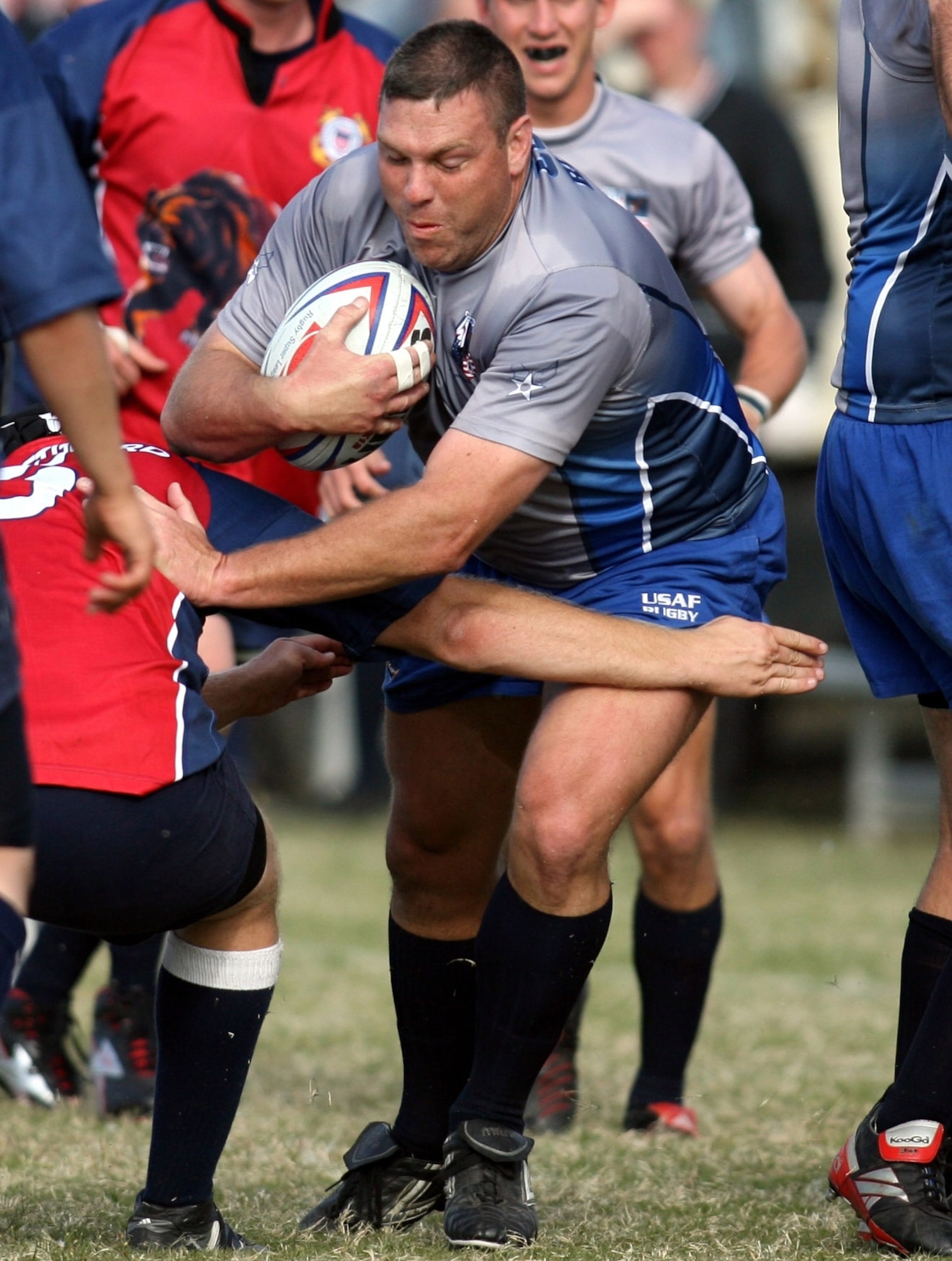 Air Force Maj. Kevin Groff runs through Coast Guard defenders during their match Oct. 24 at the Armed Forces Rugby Championship at Camp Lejeune, N.C.  The Air Force team, which went on to win its third consecutive tournament title, defeated the Coast Guard team 37-3.  (U.S. Air Force photo/Major Scott Foley)