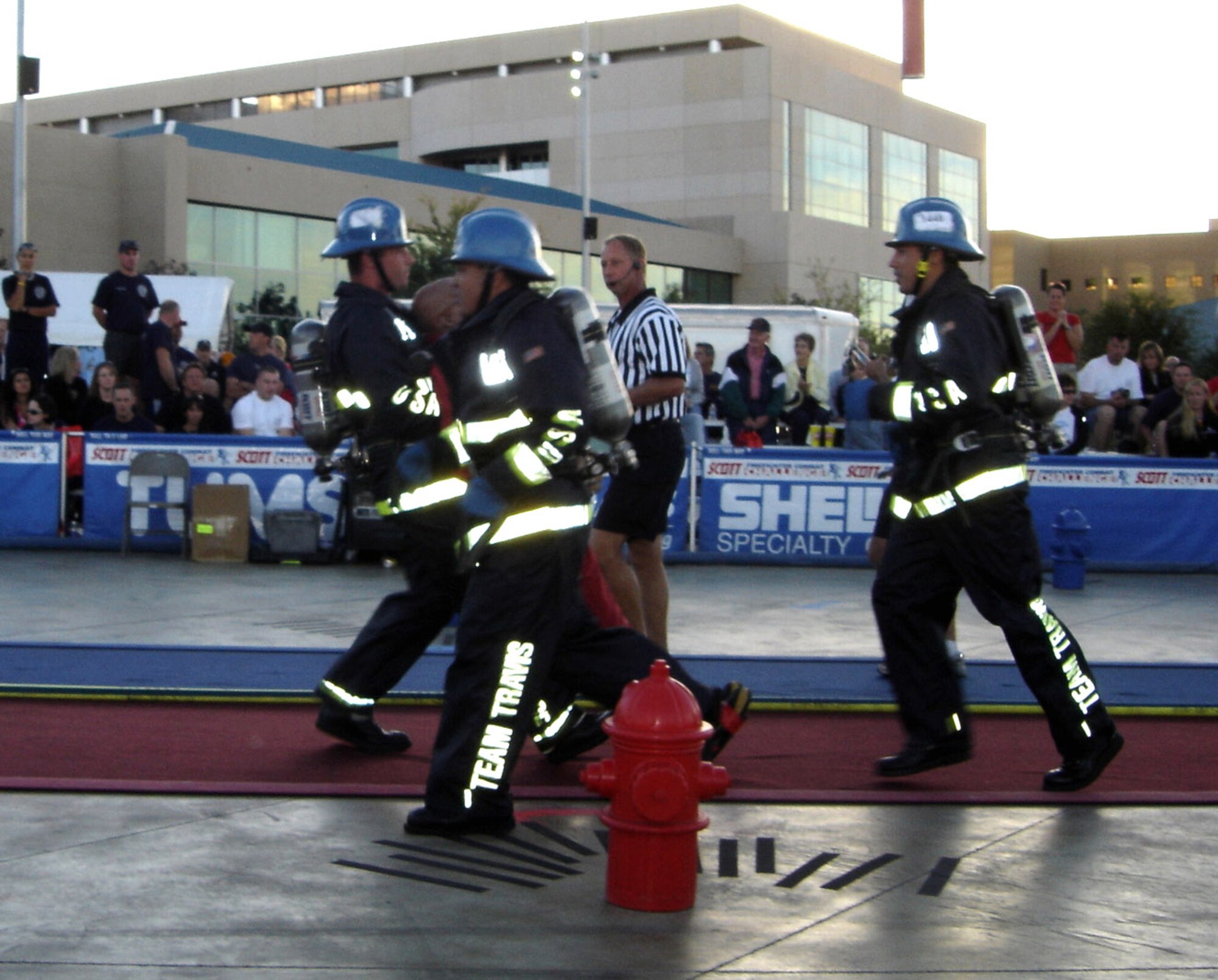 Members of the Team Travis Firefighter Combat Challenge Team race against the clock during the "dummy drag" portion of the competition. During the competition, firefighters from around the world had to perform five different tasks, including a simulated rescue of a life-sized, 175-pound "victim." Team Travis won the competition for the third consecutive year. (U.S. Air Force photo/Senior Master Sgt. Jeff Vaughn)