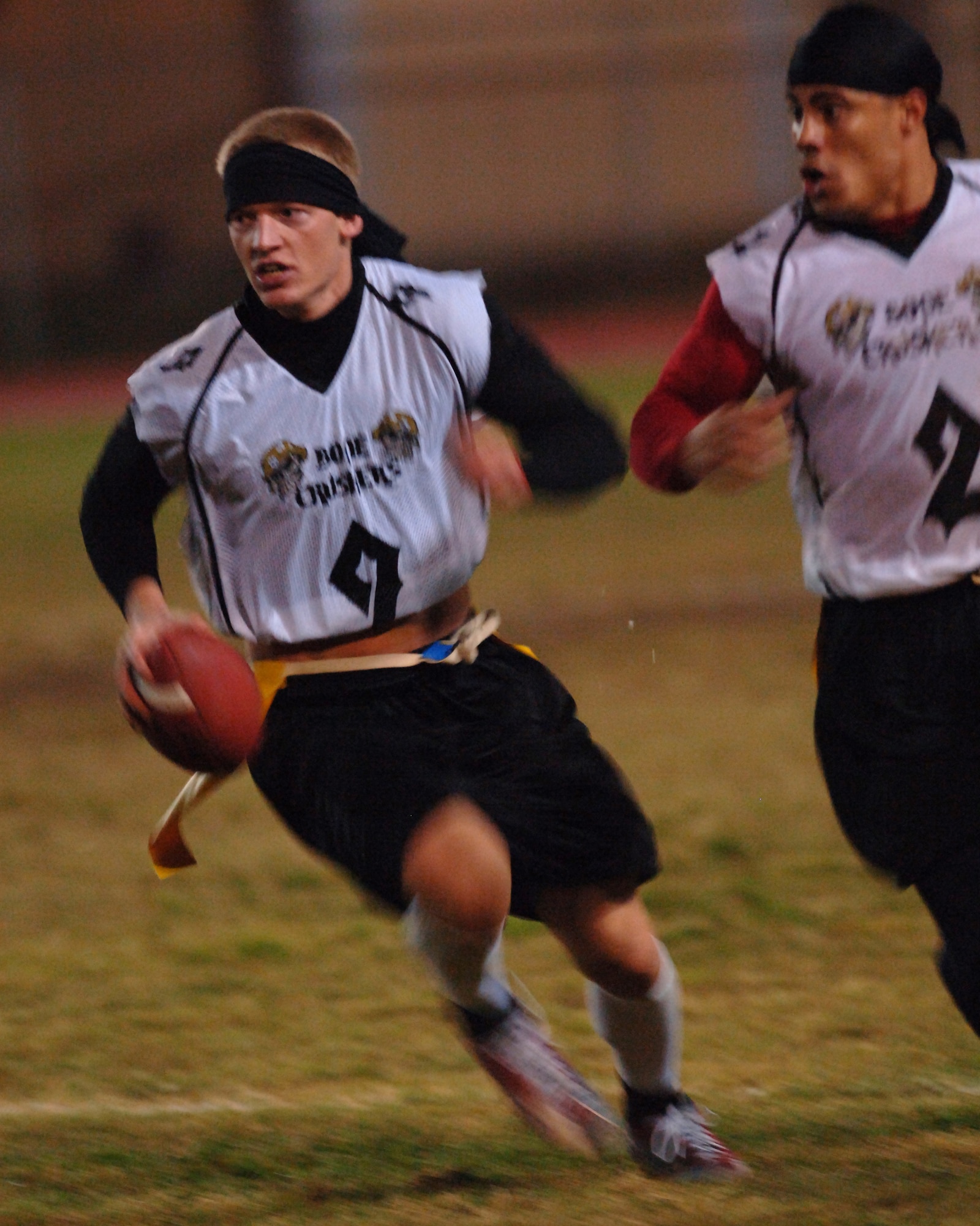 Creed Miller, left, 39th Contracting Squadron/Civil Engineer Squadron quarterback, and Edwin Lopez, CONS/CES running back, move up the field against the 39th Logistice Readiness Squadron defense Nov. 14. CONS/CES lost to LRS 18-12 in overtime. (U.S. Air Force photo by Airman 1st Class Nathan W. Lipscomb) 