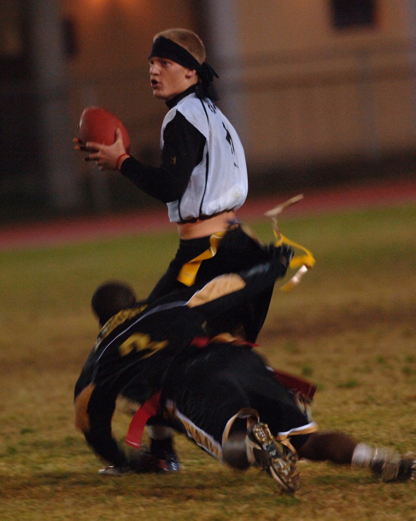 Dexter Brown, 39th Logistics Readiness Squadron defensive end, rushes in for the sack on Creed Miller, 39th Contracting Squadron/Civil Engineer Squadron quarterback, during the Incirlik Inrtramural Flag Football Championship game Nov. 14. LRS beat CONS/CES 18-12 in overtime. (U.S. Air Force photo by Airman 1st Class Nathan W. Lipscomb) 