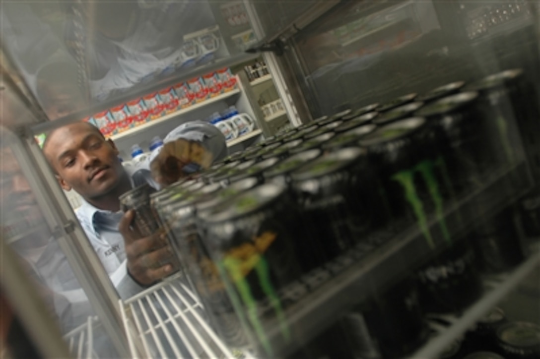 U.S. Navy Seaman Major Kenny restocks drinks in a ship store onboard the USS Kitty Hawk, Nov. 10, 2006.  