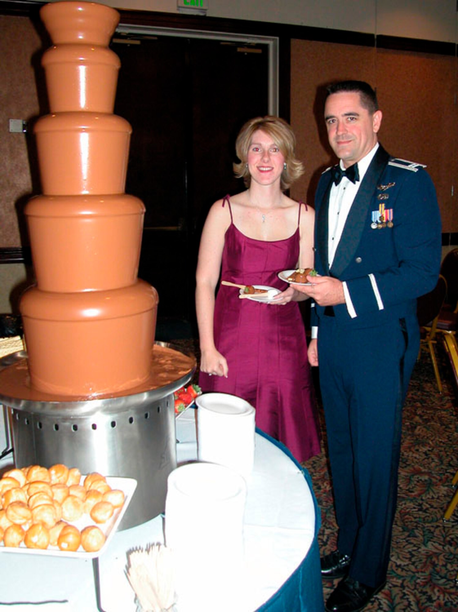 Capt. John V. Brennan, 349th Aircraft Maintenance Squadron, Maintenance Officer, and his guest, Carrie B. Fletcher enjoy a flowing fountain of Belgium chocolate and treats at the 349th Annual Awards Ball, Oct. 21.