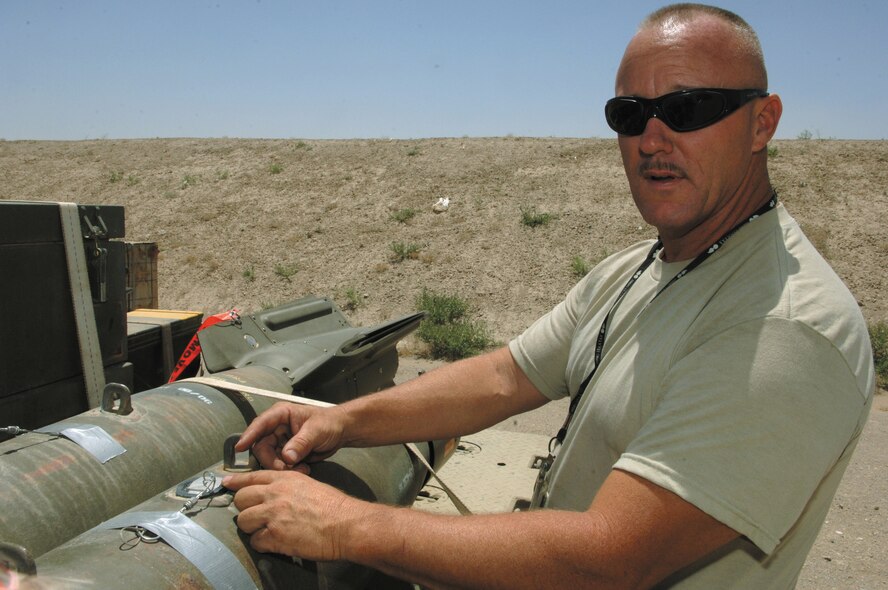 Master Sgt. Bob Jackson checks a trailer of 500-pound bombs in the munitions storage area at Bagram Airfield, Afghanistan, while deployed there in July.  Sergeant Jackson, from the 442nd Maintenance Squadron's Munitions Flight, was awarded the Airman's Medal Oct. 23, for disposing of a smoking, 120-milimeter mortar shell in August 2003 while deployed to Kirkuk Air Base, Iraq.  (U.S. Air Force photo/Maj. David Kurle)