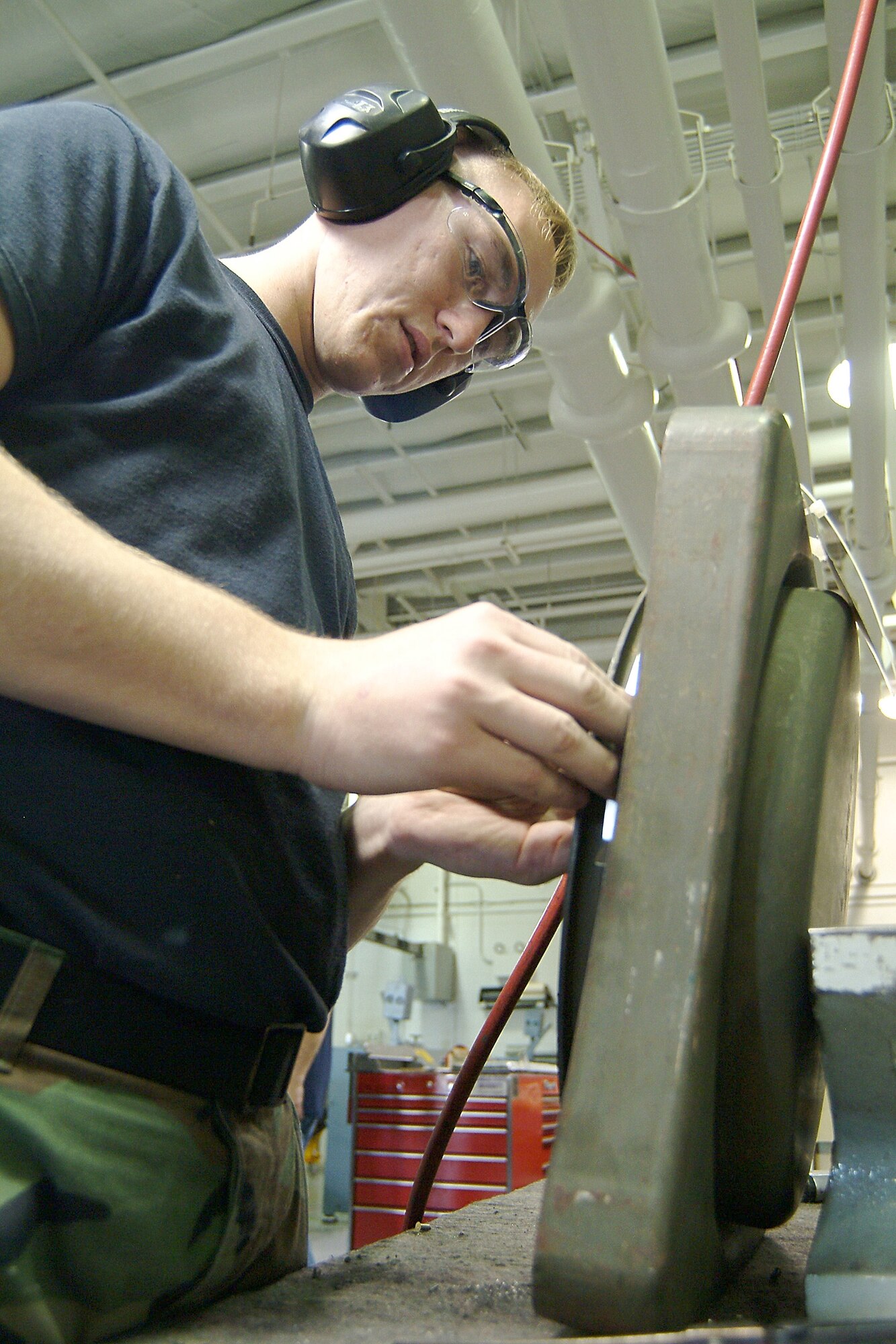 WHITEMAN AFB, Mo. -- Senior Airman Peter Young, with the 442nd Fighter Wing's, 442nd Maintenance Squadron's Structures shop, here, replaces a broken latch on a dispenser cover. (US Air Force photo/Master Sgt. Bill Huntington)
