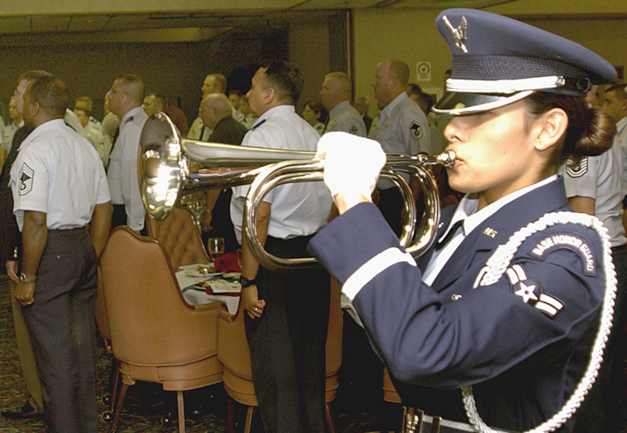 Airman 1st Class Casey Madrid, a Sheppard Honor Guard bugler, plays ‘Taps’ while guests at the annual Veterans Day luncheon stand in silence and respect Nov. 9 at the Sheppard Club. (U.S. Air Force photo/Harry Tonemah).