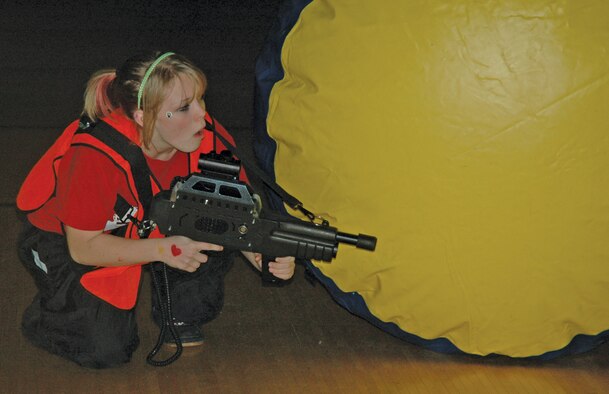 EIELSON AIR FORCE BASE, Alaska -- Brianna Presley, daughter of Tech. Sgt. Sonya Foster, 354th Contracting Squadron, tests out new laser tag equipment with peers from Ben Eielson High School Oct. 27 at the base fitness center.