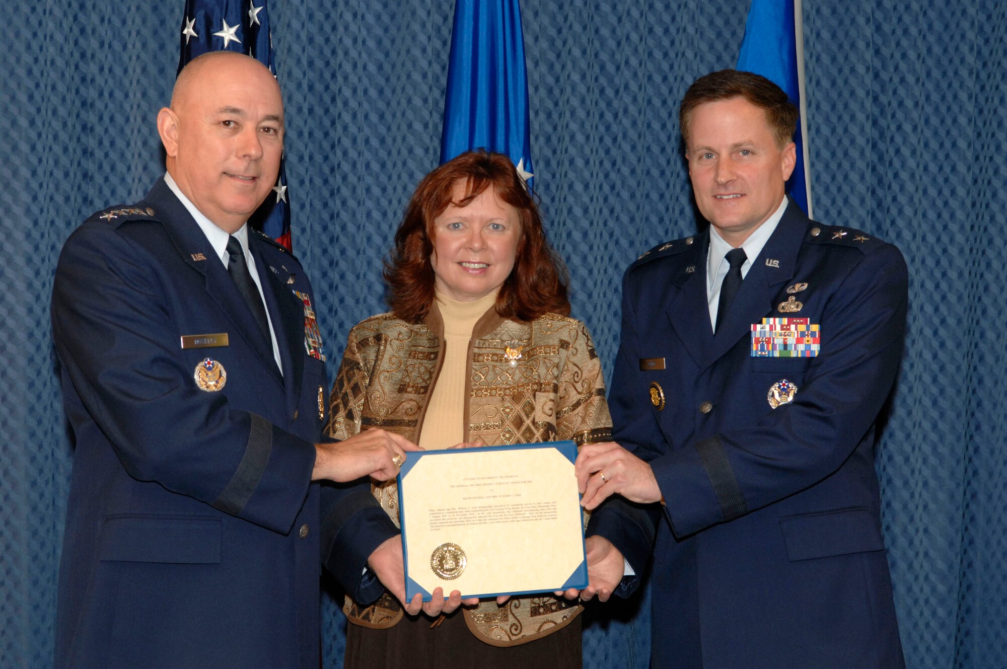 Maj. Gen. William T. Lord and his wife, Cynthia, receive the O'Malley Award from Air Force Chief of Staff Gen. T. Michael Moseley Nov. 15 at the Pentagon. The award is given to the wing commander and spouse who were the most involved in their community. General Lord was the base commander of Keesler Air Force Base, Miss., where he dealt with four hurricanes to include Katrina and Rita that devasted the Gulf Coast. (U.S. Air Force photo/Tech. Sgt. Cohen Young)