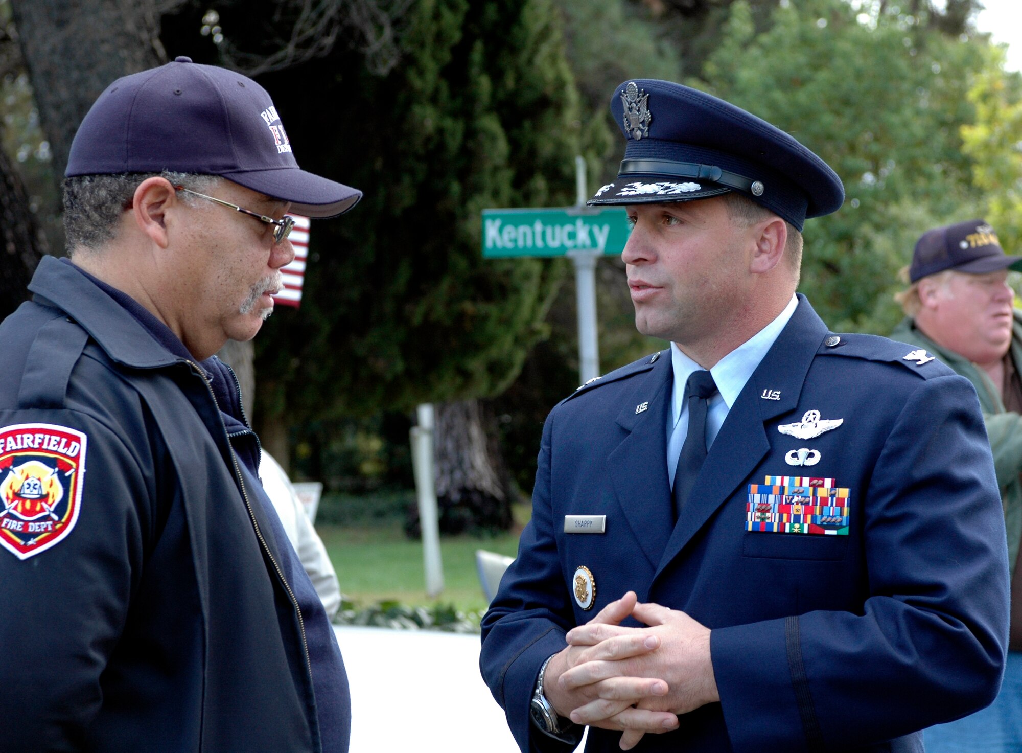 Col. Tom Sharpy, 60th Air Mobility Wing vice commander, speaks with a member of the Fairfield Fire Department. Approximately 142 Team Travis members participated in this year’s parade. Colonel Sharpy was one of the parade’s grand marshals. (U.S. Air Force photo by Staff Sgt. Candy Knight/ 60th Air Mobility Wing Public Affairs)