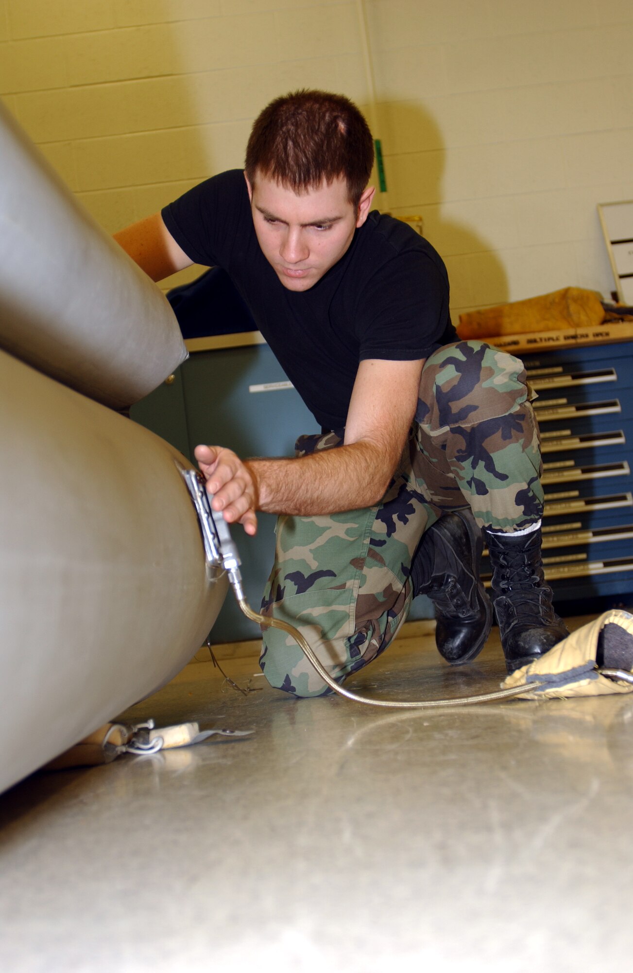 GRAND FORKS AFB, N.D. -- Airman 1st Class Kevin Westlund, a survival equipment apprentice, fills up an egress slide to inspect it. Most surivial equipment is inspected every 180 days but deployments, exercises and wear can shorten the time between inspections. (photo/Airman 1st Class Ashley Coomes)