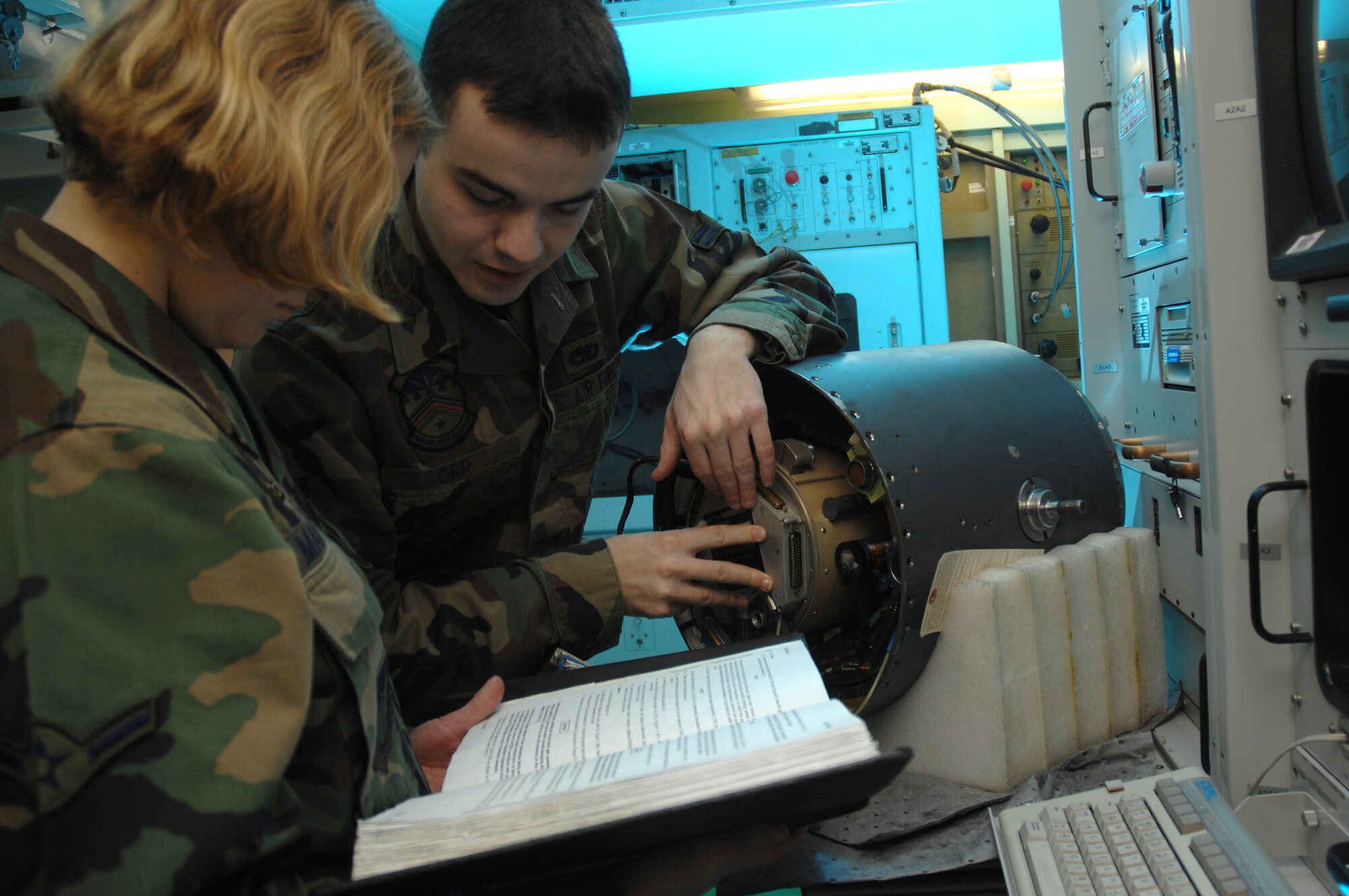Airman 1st Class Matthew Orr and Airman Heather Mangerson install a slip ring onto an F-16 targeting pod Nov. 15 at Eielson Air Force Base, Alaska. Airmen Orr and Mangerson work in the 354th Maintenance Squadron at Eielson AFB. (U.S. Air Force photo/Staff Sgt. Joshua Strang)