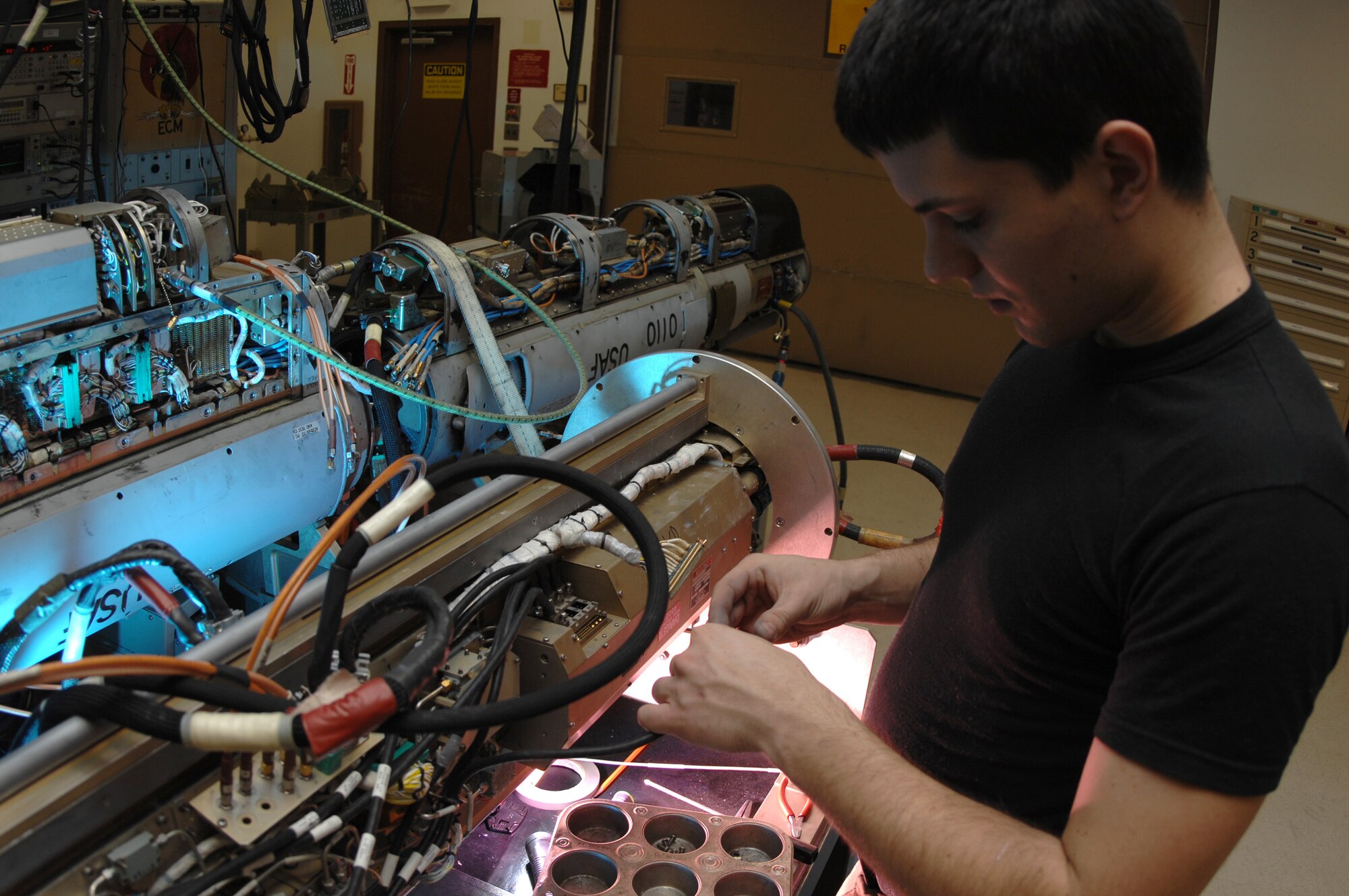 Airman 1st Class Robert Wulff troubleshoots a high voltage power supply on an ANALQ1 84 Electronic Counter Measures pod Nov. 15 at Eielson Air Force Base, Alaska. Airman Wulff is an electronic warfare systems apprentice with the 354th Maintenance Squadron at Eielson AFB. (U.S. Air Force photo/Staff Sgt. Joshua Strang)