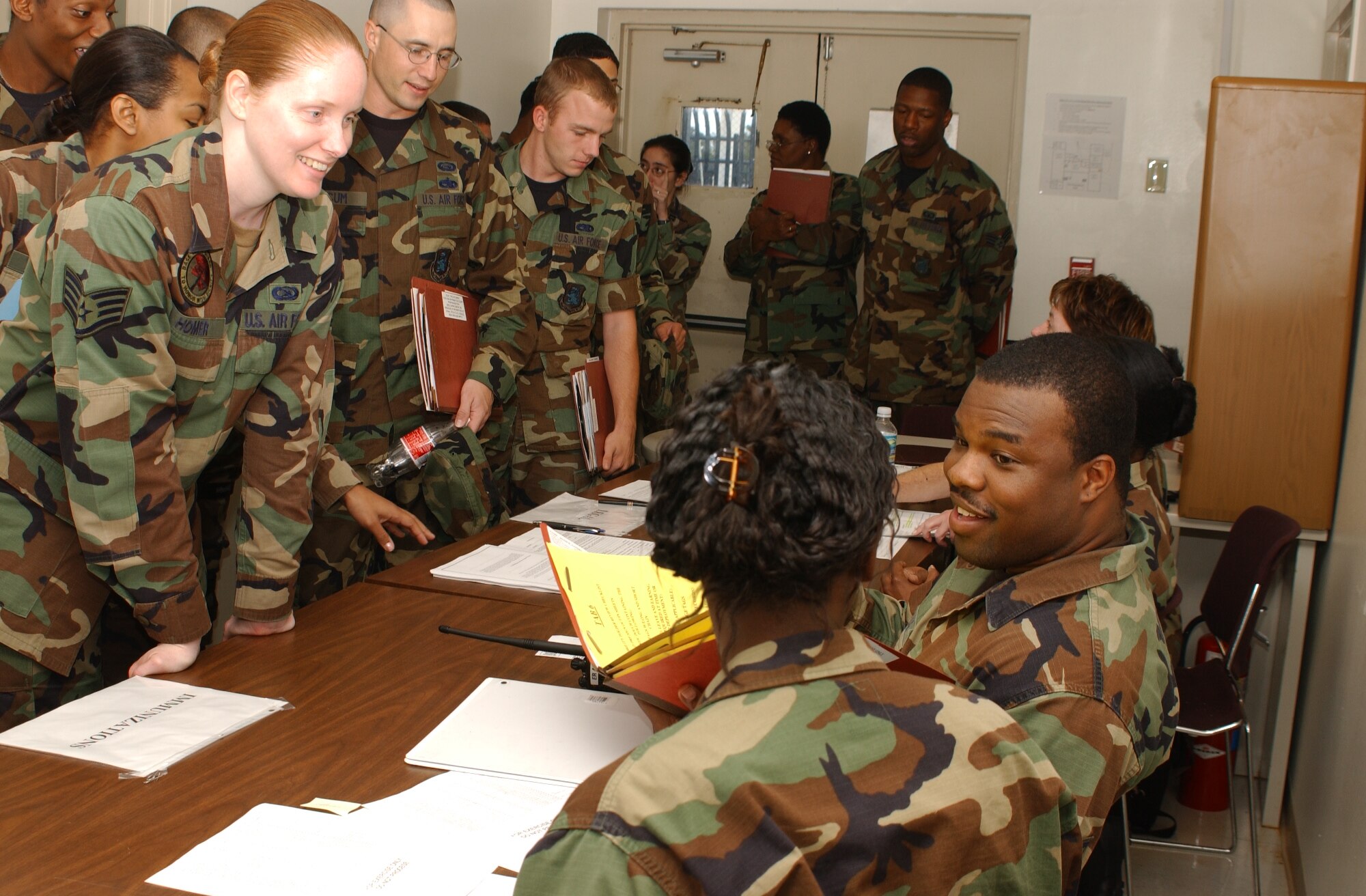 Staff Sgt. Sandra Homer, left, 81st Contracting Squadron, has her immunization records reviewed by Staff Sgt. Javon Craig, 81st Medical Operations Squadron, Nov. 7 during the 81st Training Wing's deployment exercise. (Photo by Kemberly Groue)