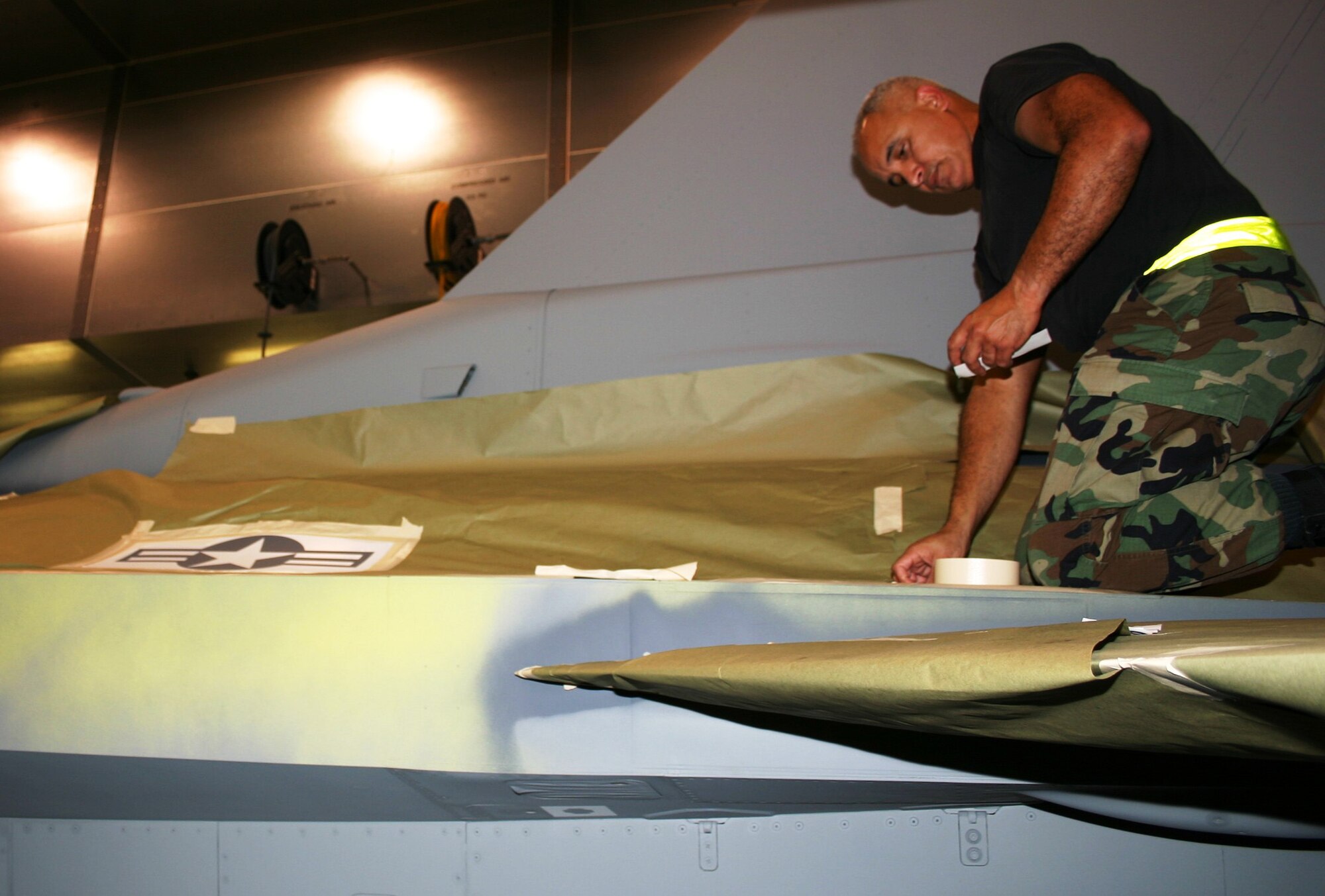 Tech. Sgt. Aldo Aguero, a structural maintenance technician from the 482nd Maintenance Group, prepares a stencil on an F-16 prior to painting Nov. 4 here at Homestead Air Reserve Base, Fla. (U.S. Air Force photo/Master Sgt. Ray Sarracino)