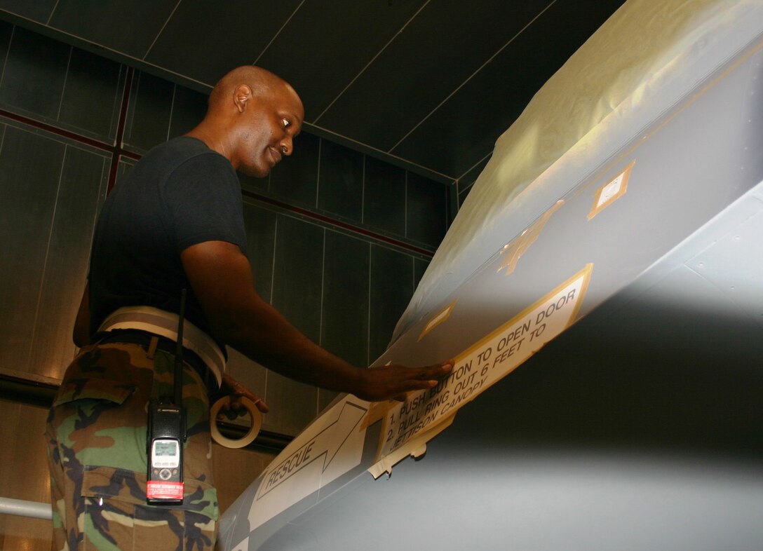 Tech. Sgt. George Walker, a structural maintenance technician from the 482nd Maintenance Group, prepares a stencil on an F-16 prior to painting Nov. 4 here at Homestead Air Reserve Base, Fla. (U.S. Air Force photo/Master Sgt. Ray Sarracino)