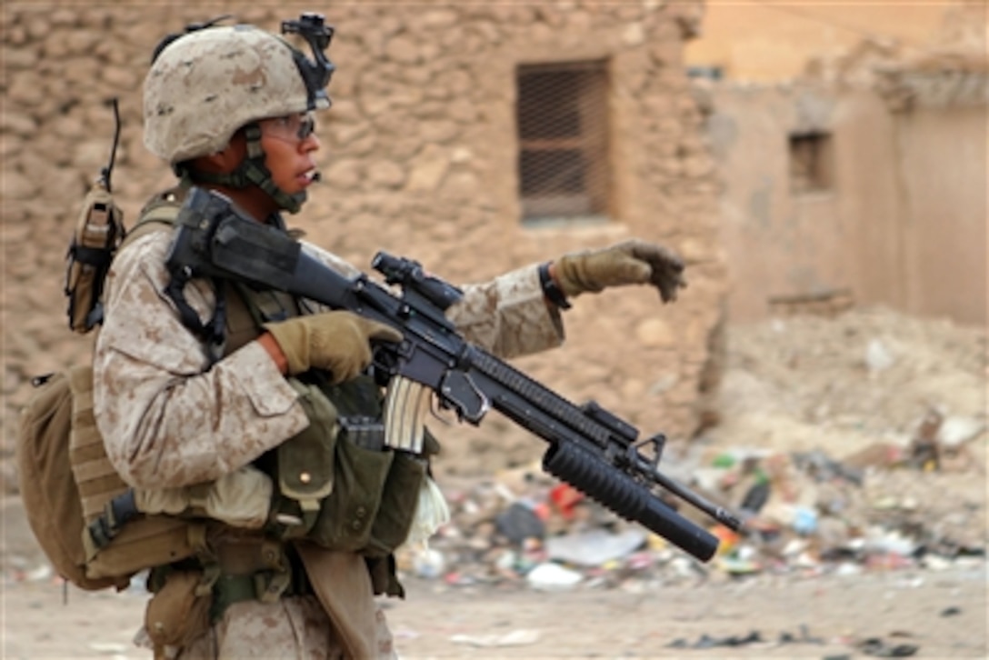 Marine Lance Cpl. Jason L. Paul patrols through the streets of Haqlaniyah, Iraq, on Oct. 22, 2006.  Paul is attached to 2nd Battalion, 3rd Marine Regiment, Regimental Combat Team 7, I Marine Expeditionary Force (Forward).  