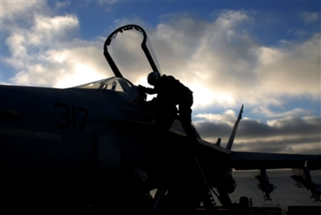 A U.S. Navy pilot exits the cockpit of an F/A-18C Super Hornet aircraft from the "Blue Diamonds" of Strike Fighter Squadron 146 after conducting flight operations aboard the USS John C. Stennis, Nov. 15, 2006.