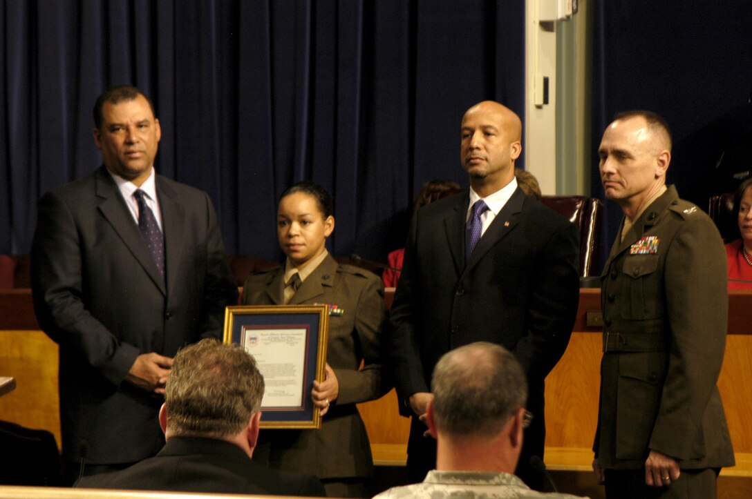 Petty Officer 2nd Class Jennifer Woldeselasie, a Marine Forces Reserve religious programs specialist, receives the exceptional Military Service Award from Ray Nagin, mayor of New Orleans; Oliver Thomas, city council president; and Col. Jim Kinnerup, Marine Forces Reserve chief of staff. The award was given during a joint service ceremony honoring Military Day in the city Nov. 16.