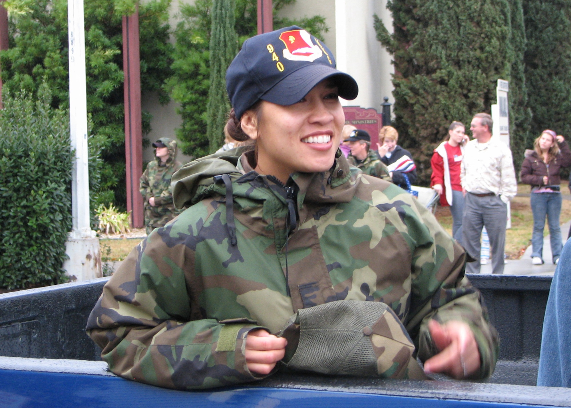 Air Force Reservist Staff Sgt. Andrea Schmidt, 940th Aircraft Maintenance Squadron avionics specialist, smiles at the crowd during the Marysville Veteran's Day Parade Nov. 11, 2006. More than 40 Reservists, retirees and family members from the 940th Air Refueling Wing at Beale Air Force Base, Calif. joined active duty members, also from Beale, to hand out American flags and Air Force goodies to the crowd during the rainy parade. (U.S. Air Force photo/James Martinez)