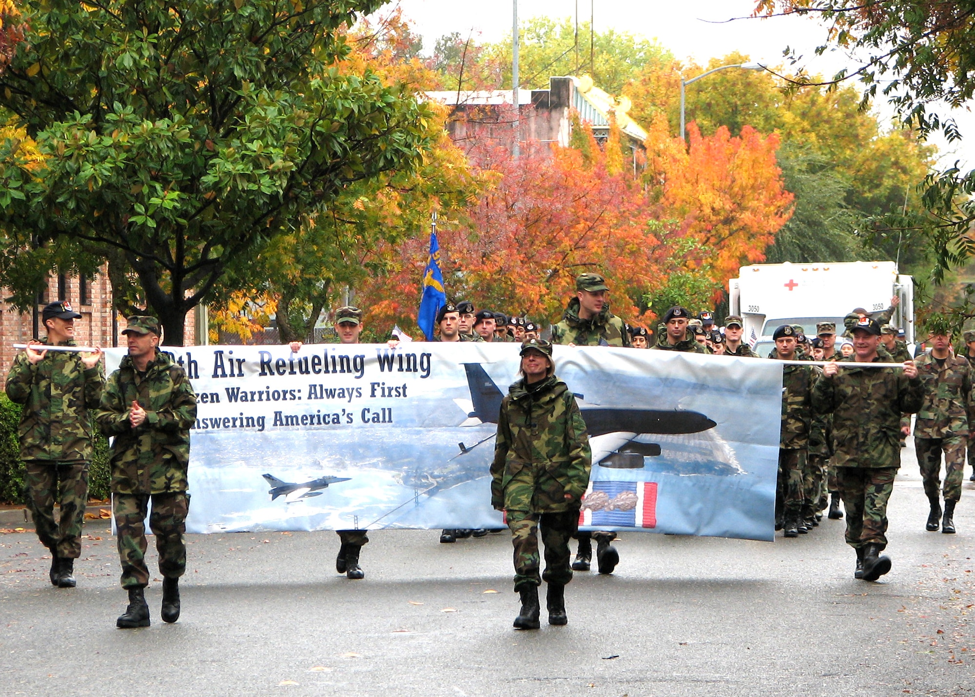 Air Force Reservists Lt. Col. Jonathan Ellis, 13th Reconnaissance Squadron commander, and Lt. Col. Abby Uptegraff, 940th Maintenance Squadron project officer, lead both Air Force active duty and Reserve marchers from Beale Air Force Base, Calif. during the Marysville Veteran's Day Parade Nov. 11, 2006. More than 40 Reservists, retirees and family members from the 940th Air Refueling Wing at Beale marched and handed out American flags and Air Force goodies to the crowd during the rainy parade. (U.S. Air Force photo/James Martinez)