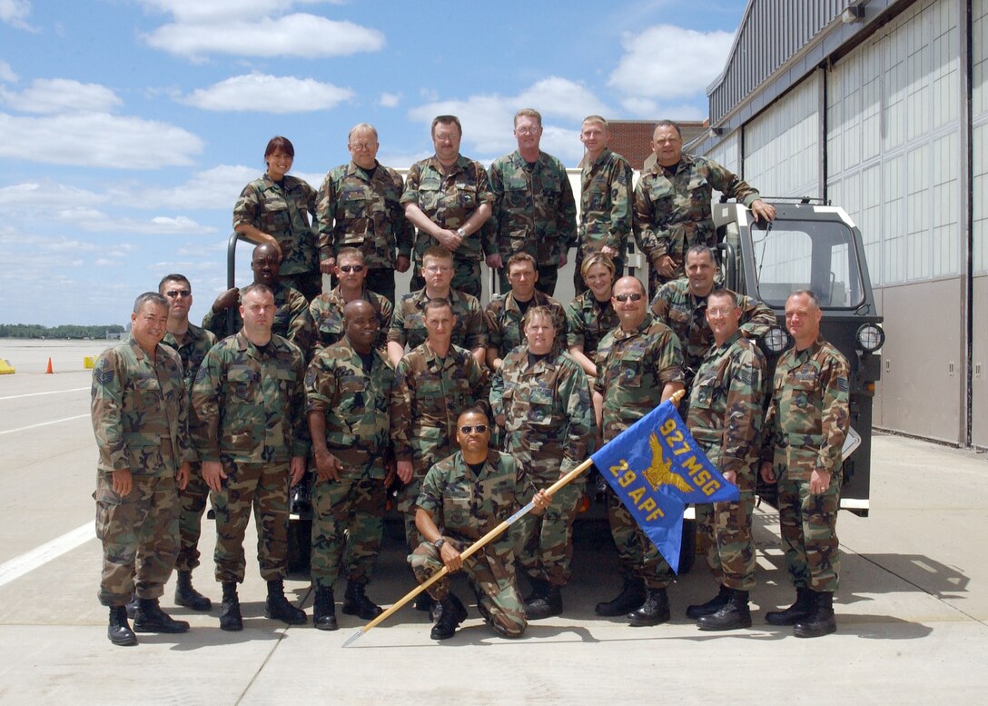 29 Aerial Port Flight members pose for a final group photo following deactivation ceremonies. Some members have relocated while others have found a new home with a different unit in the 927th Air Refueling Wing (Air Force Reserve Command).