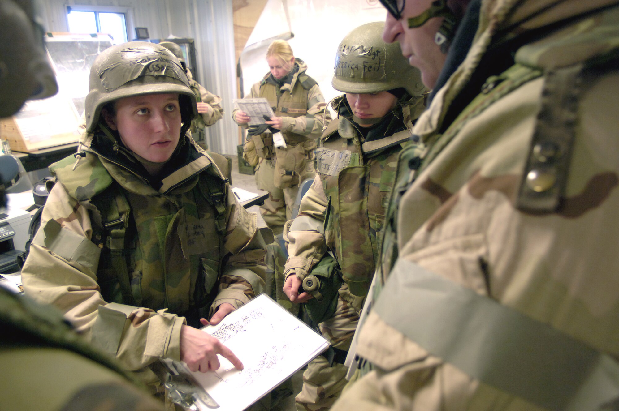 Staff Sergeant Jenna Klinkenberg briefs fellow readiness Airmen on the information obtained during a site survey of a potentially contaminated room Nov. 16. The site survey was part of a readiness training exercise at Fort Leonard Wood, Mo. The exercise is designed to give readiness Airmen training scenarios developed from lessons learned during operations Iraqi Freedom and Enduring Freedom. The two-day exercise is the part of a two-week training class here.  Sergeant Klinkenberg is with the 3rd Civil Engineer Squadron, Elmendorf Air Force Base, Alaska.  (U.S. Air Force photo/Senior Airman Brian Ferguson) 
