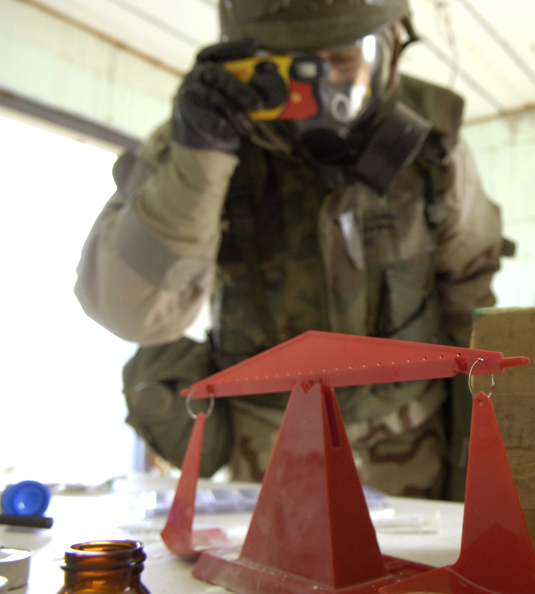 Staff Sgt. Jenna Klinkenberg takes photos during a site survey of a potentially contaminated room Nov. 16.  The survey was part of a readiness training exercise at Fort Leonard Wood, Mo. The exercise is designed to give readiness Airmen training scenarios developed from lessons learned during operations Iraqi Freedom and Enduring Freedom. The two-day exercise is the part of a two-week training class here.  Sergeant Klinkenberg is with the 3rd Civil Engineer Squadron, Elmendorf Air Force Base, Alaska.  (U.S. Air Force photo/Senior Airman Brian Ferguson) 