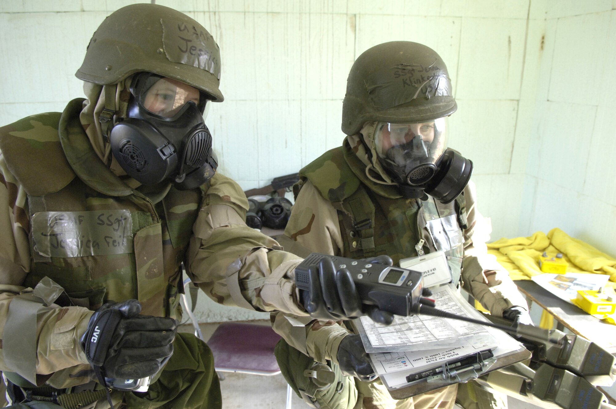 Staff Sgts. Jessica Feil (left) and Jenna Klinkenberg look over their notes while performing a site survey of a potentially contaminated room Nov. 16.  The survey was part of a readiness training exercise at Fort Leonard Wood, Mo. The exercise is designed to give readiness Airmen training scenarios developed from lessons learned during operations Iraqi Freedom and Enduring Freedom. The two-day exercise is the part of a two-week training class here. Sergeant Feil is with Detachment 1, 823rd Red Horse, Tyndall Air Force Base, Fla., and Sergeant Klinkenberg is with the 3rd Civil Engineer Squadron, Elmendorf AFB, Alaska. (U.S. Air Force photo/Senior Airman Brian Ferguson) 